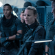A scientist from the future (Yvonne Strahovski) stands surrounded by soldiers in a scene from sci-fi action movie The Tomorrow War.